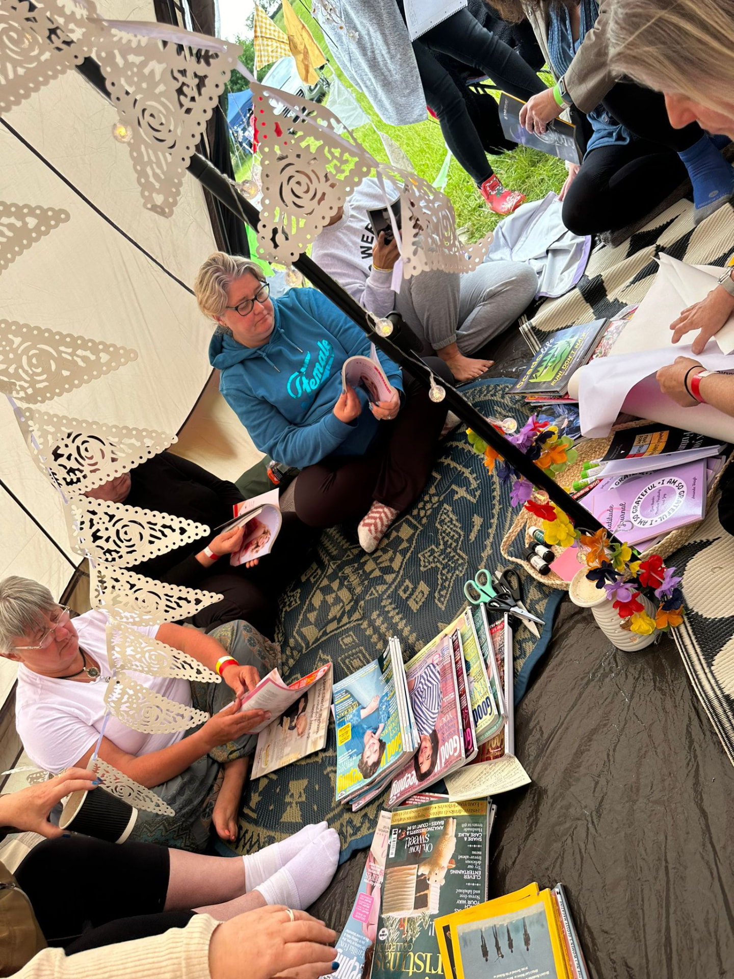A group taking part in a creative visioning workshop inside a tent