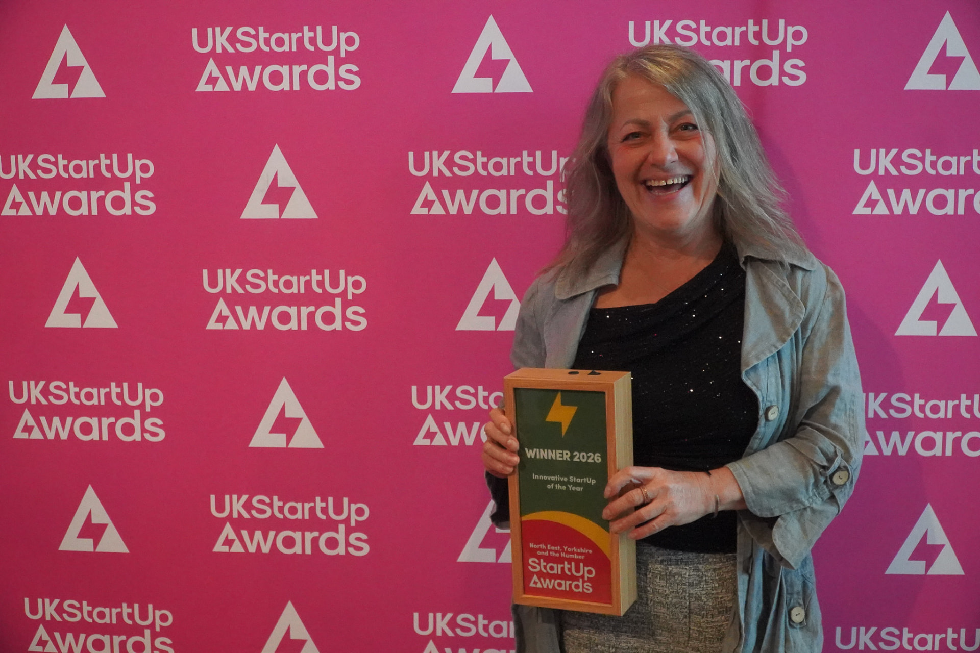 Amanda Haigh holding the UK StartUp Awards Innovative StartUp of the Year 2026 trophy